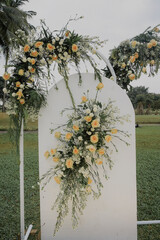 yellow rose and white flower on wedding floral decorations set. elegant outdoor white wedding concept