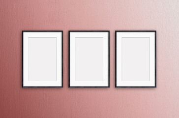 Three black photo frames isolated on painted textured wall