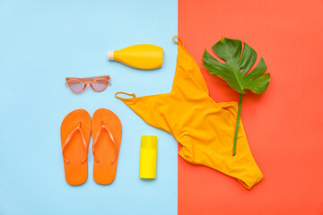 Beach accessories on color background