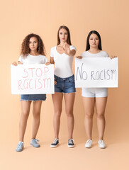 Women of different nationalities with placards on color background. Stop racism