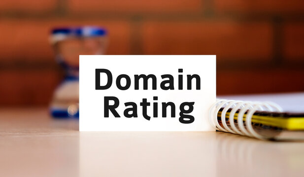 Domain rating text n white sheet with notepad and hourglass