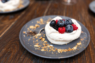 Sweet cakes with summer berries on a wooden table. Party, sweet table. Summer offer desserts in the restaurant.