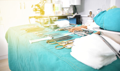 Surgical instruments, surgery, placed on a sterile green cloth, soft focus