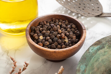 Black pepper and spice concept in wooden bowl