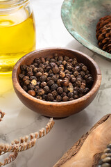 Black pepper and spice concept in wooden bowl