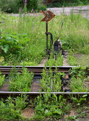 Switch the railway tracks of the old railway line overgrown with grass