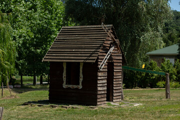 Fototapeta na wymiar wooden house in the summer park