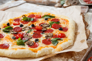 Assorted pizza with different fillings served on wooden table with ingredients