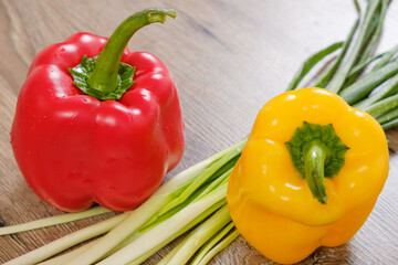 Sweet and spicy peppers on wooden background in studio photo.