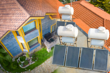 Solar panels near the house. Concept - installation of solar cells. Boilers for heating water. Sale of power generating equipment. Concept - green energy. Solar water heater.