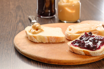 peanut butter sandwich with jam on cutting board
