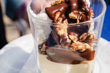 Bowl of chocolate ice cream on blue background.