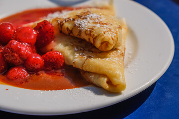 freshly prepared pancakes with strawberries