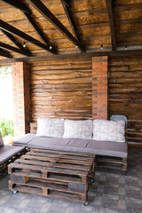 Furniture from pallets in the gazebo. Sofa and table in the barbecue lounge area.