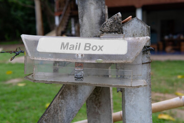 An old dusty mailbox That is in front of the house, Self made mailbox from a plastic plan
