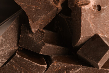 Pieces of dark chocolate as background, closeup