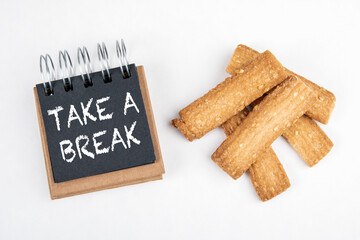 TAKE A BREAK. Work and study load, stress and rest concept. Black notebook and cookies