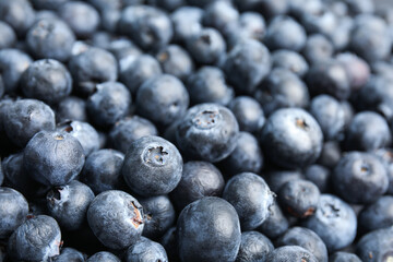Fresh tasty blueberries as background, closeup view