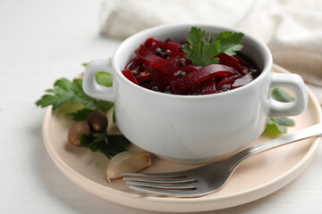 Delicious pickled beets on white wooden table