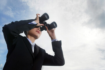 Businesswoman using binoculars