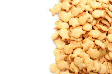 Delicious crispy goldfish crackers on white background, top view