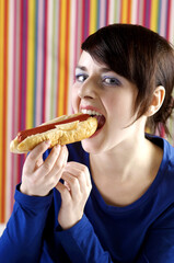 Woman eating hot dog