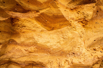 Sandstone wall background. Nature yellow sand textured background 