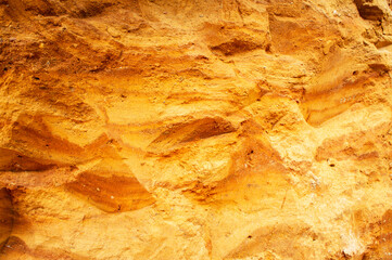 Sandstone wall background. Nature yellow sand textured background 