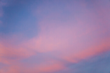 Pink sunset sky with pearly clouds