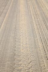 Distinct prints of 4 wheel driving tracks on sand