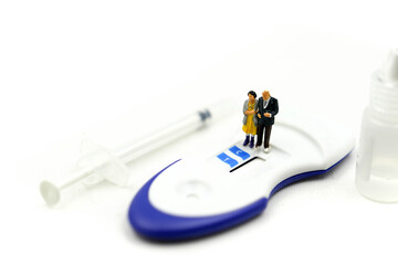 Miniature people : Couple and Doctor with Positive pregnancy test Sperm,birth of a healthy child concept.
