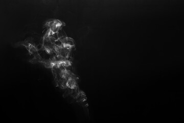 Figured smoke on a dark background. Abstract background, design element, for overlay on pictures