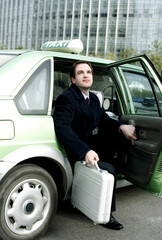 Businessman getting out from a taxi