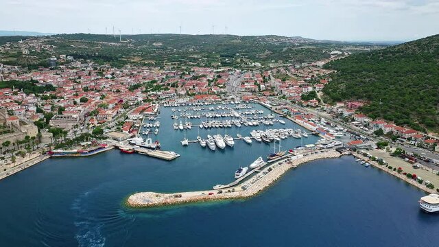 Marina Aerial, Cesme, Turkey. This stock video features aerial drone footage of a marina full of yachts and boats in the Aegean Sea at Cesme, Turkey.