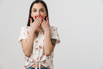 Photo of surprised woman covering her mouth and looking at camera