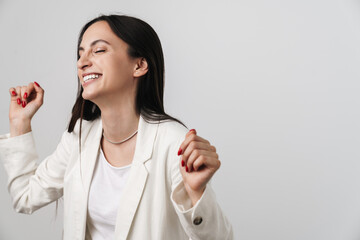Photo of young joyful businesswoman laughing and dancing