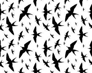 Seamless pattern of birds silhouettes on a white background
