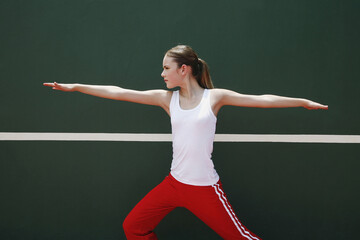 Woman exercising in the tennis court