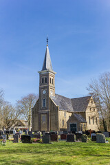 Fototapeta na wymiar Historic Nicolaaskerk church and graveyard of Hemelem, Netherlands