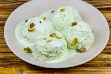 Pistachio ice cream on wooden table