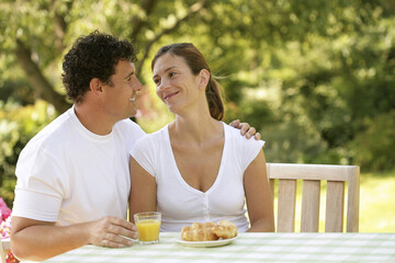 Couple sitting at the picnic table looking at each other