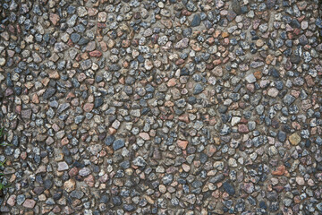 Photo of crushed stone and gravel on the ground. Texture background white gray stones on a black earth background. Image of broken stones