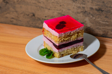 Vegan, raw fruit cake. Healthy food. Piece of cake on a white plate. Sweet food. Sweet delicious dessert.