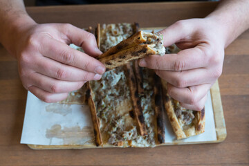 Turkish pizza pita with meat,man hands