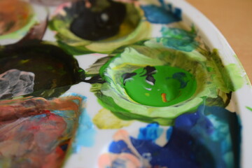 Paint pot aquarel watercolor paints with water and color applied with a paint brush