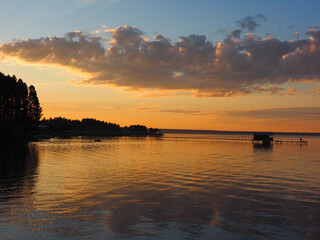 Sunset, summer, beautiful clouds at sunset. Pier on the big Kama river. Ural, Russia, Perm...