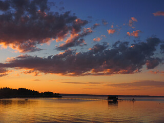 Fototapeta premium Sunset, summer, beautiful clouds at sunset. Pier on the big Kama river. Ural, Russia, Perm Territory, Elovo.