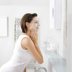 Woman applying facial mask