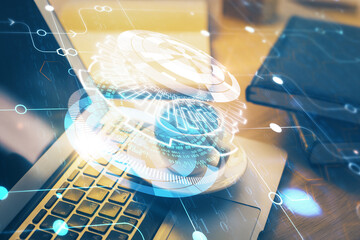 Double exposure of desktop computer and technology theme hologram. Concept of software development.