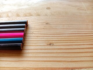 Group of colorful wooden pencils on wooden background. Idea concept for education about drawing and writing.  
